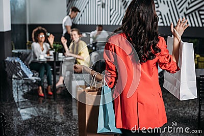 woman with shopping bags going to her friends Stock Photo