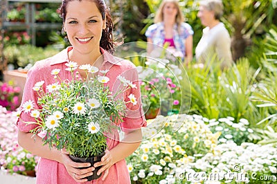 Woman shopping for flowers at garden centre Stock Photo