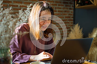 An Asian beautiful woman is working in the coffee shop Stock Photo