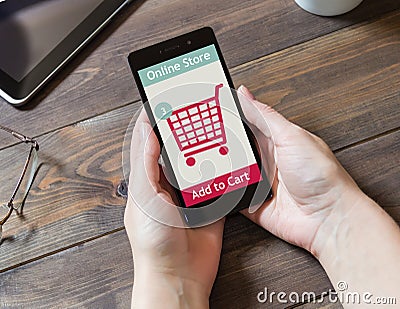 A woman is shopping at the online shop. Shopping cart icon. Ecommerce. Stock Photo