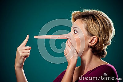 Woman touching her long nose because of lie . People,lifestyle and emotions concept Stock Photo