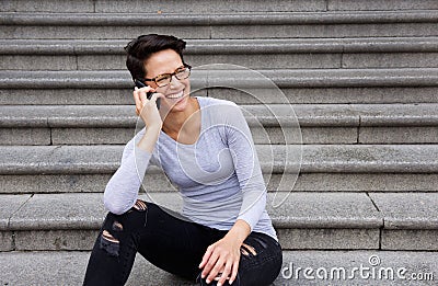 Woman with short hair and glasses talking on mobile phone Stock Photo