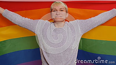 Woman with short hair with rainbow LGBT flag celebrate parade show tolerance same sex marriages Stock Photo