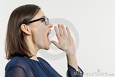 A Woman shouting, screaming portrait in profile, white background. Stock Photo