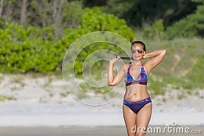 Woman show bikini relax with sunshine on beach Stock Photo