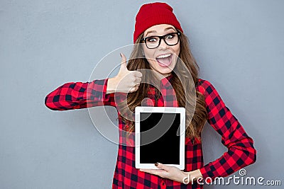 Woman showing blank tablet computer screen and thumb up Stock Photo