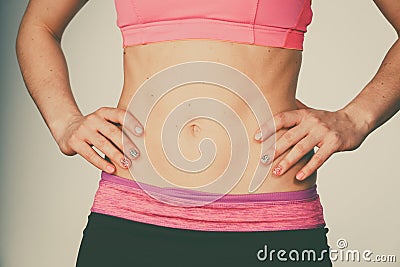 Woman showing some strong abs and flat belly Stock Photo