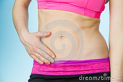 Woman showing some strong abs and flat belly Stock Photo