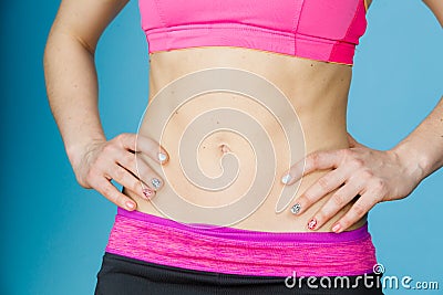 Woman showing some strong abs and flat belly Stock Photo