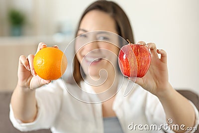 Woman showing two different fruits Stock Photo