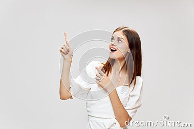 Woman shows a close finger up smile white dress Copy Space Stock Photo