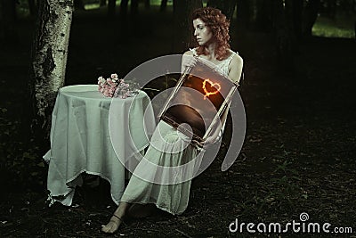 Woman shows her burning heart Stock Photo