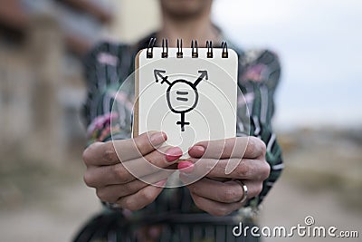 Woman shows notepad with a transgender symbol Stock Photo