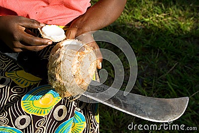 Woman shows opened coconut. Stock Photo
