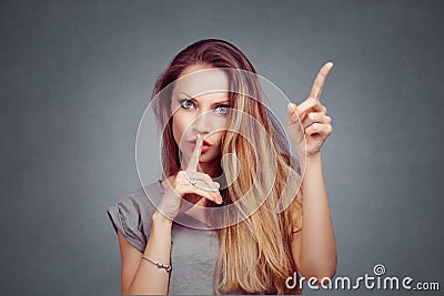 Woman shows shh, silence and attention listen to me signs Stock Photo