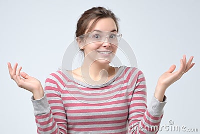 Woman shrugging hands and expressing confusion, not having any clue Stock Photo