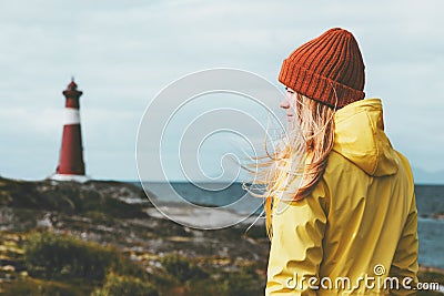 Woman sightseeing lighthouse sea landscape in Norway Travel Lifestyle concept scandinavian vacations outdoor Stock Photo