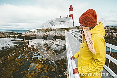 Woman sightseeing Norway lighthouse landscape Stock Photo