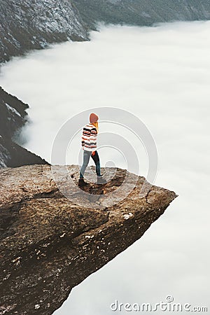 Woman sightseeing Trolltunga rocky cliff Stock Photo