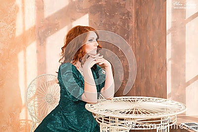 Woman siiting near window, vintage interior, luxury Stock Photo
