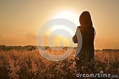 Woman silhouette waiting for summer sun Stock Photo