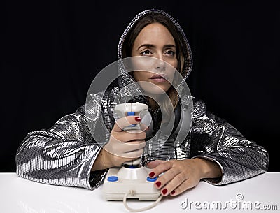 Woman with silver costume and computer joystick Stock Photo