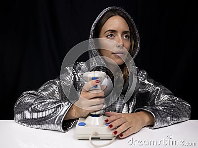 Woman with silver costume and computer joystick Stock Photo