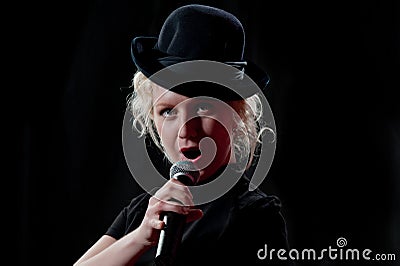 Woman singing in microphone Stock Photo