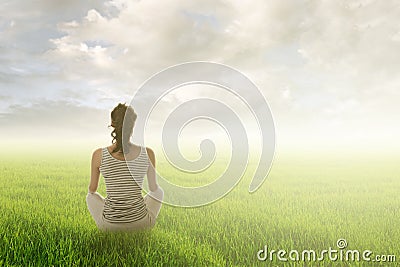 Woman sit on grassland Stock Photo