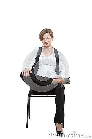 Woman sits astride a chair. legs crossed, fixed Stock Photo