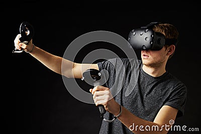 Woman Sits On Sofa At Home Wearing Virtual Reality Headset Stock Photo