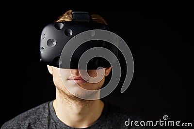 Woman Sits On Sofa At Home Wearing Virtual Reality Headset Stock Photo