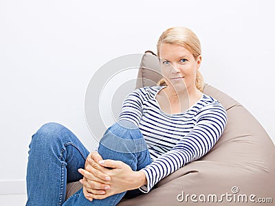 Woman sitting on a beanbag Stock Photo