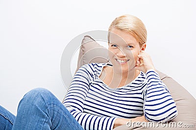 Woman sitting on a beanbag Stock Photo