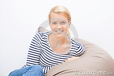 Woman sitting on a beanbag Stock Photo