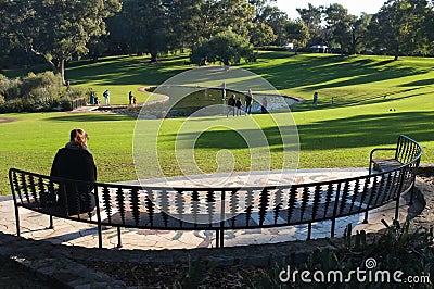 Woman sitting on the bench at the park Editorial Stock Photo