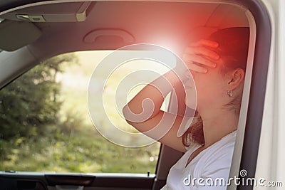 Woman sitting in the car suffering from vertigo or dizziness or other health problem of brain or inner ear Stock Photo