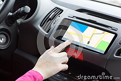 Woman sitting in a car and touch play finger in a navigation map Stock Photo