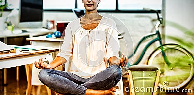 Woman sitting on chair and performing yoga Stock Photo