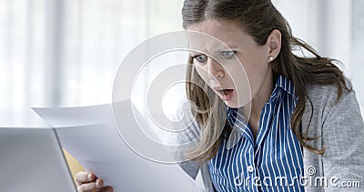 Disappointed woman reading a rejection letter Stock Photo