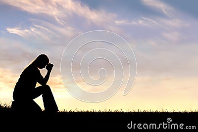 Woman Sitting Down in Prayer Silhouette Stock Photo