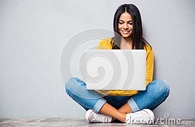 Woman sitting on the floor and using laptop Stock Photo