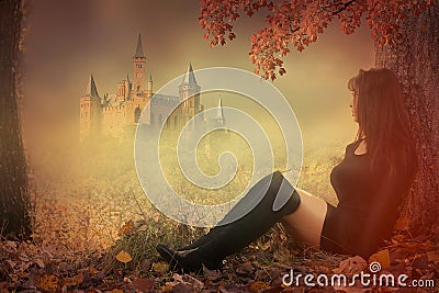 Woman sitting in front of a castle Stock Photo