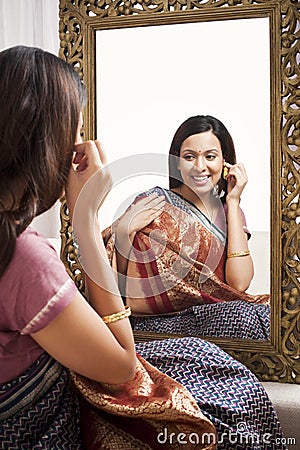 Woman sitting in front of mirror Stock Photo