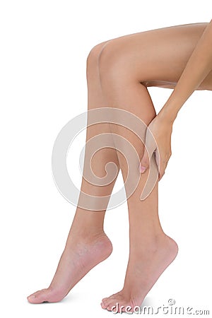Woman sitting and holding her beautiful Healthy long leg with massaging calf in pain area. Stock Photo