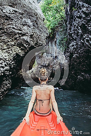 Woman sitting in kayak in the tropical calm lagoon Stock Photo