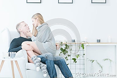 Woman sitting on man`s laps Stock Photo