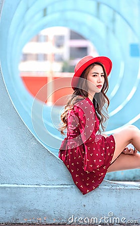 Woman sitting in the middle of the blue circle tunnel Is a parking lot used to shoot music videos for famous singers in Hongkong Stock Photo