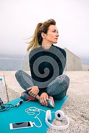 Woman sitting with sport accessories Stock Photo