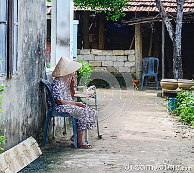 A woman sitting on street in Hoi An, Vietnam Editorial Stock Photo